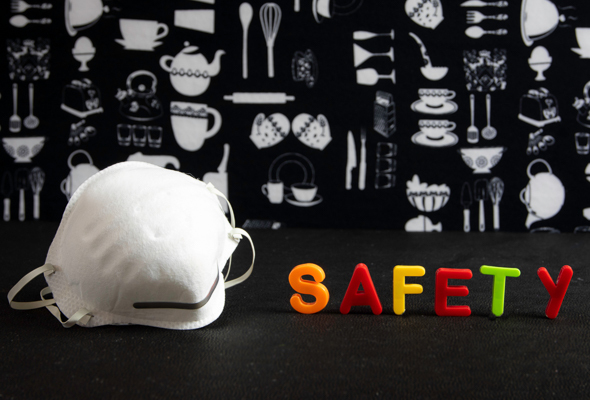 A face mask next to the word Safety in plastic letters