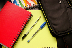 A picture of notebooks and pens