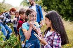 Kids outdoors examining nature
