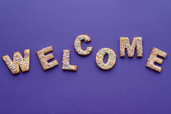 Letters spelling out the word welcome on a purple background