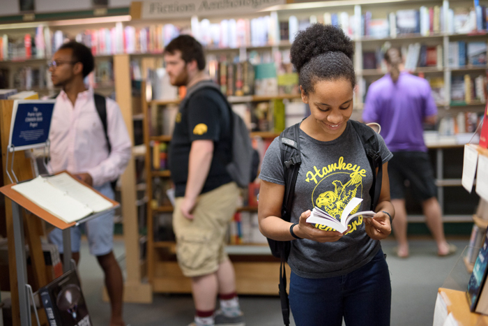 A group of college students browses in a bookstore