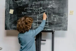 A child writes on a chalkboard